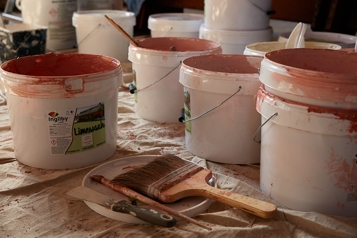 Buckets of limewash for heritage restoration
